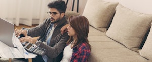 Young couple paying bills online