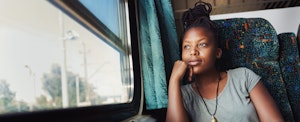 Woman looking out the window of a train