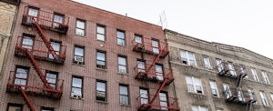 Apartment buildings pictured against a cloudy sky