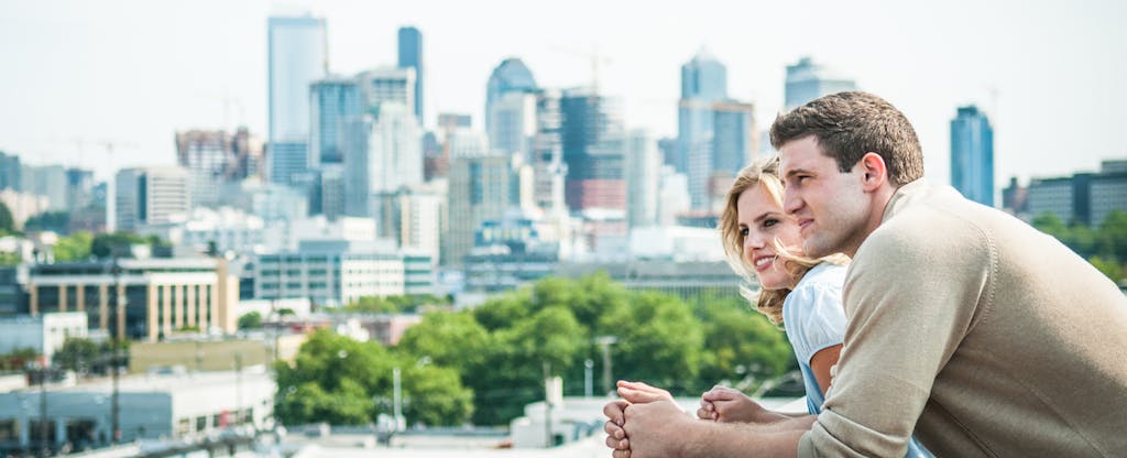 Couple on rooftop contemplates the difficulty of buying a home with bad credit