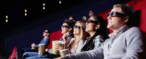 Family wearing 3D glasses to watch a film in a movie theater to help overcome debt fatigue