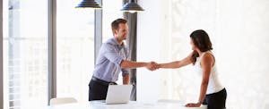 Man shaking hands with a job candidate who is wondering if an employer can check credit scores.