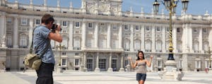 Tourists taking pictures at the Royal Palace Madrid, unconcerned about foreign transaction fees