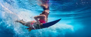 Underwater view of a woman surfing