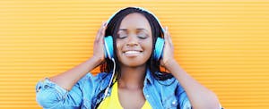 Smiling woman listens to headphones