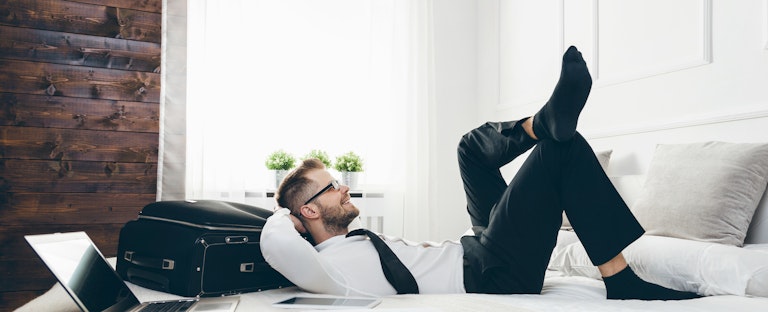 Businessman relaxing after using credit card travel insurance