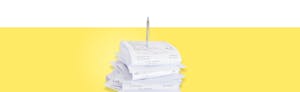 Self-employment taxes, represented by a stack of receipts against a yellow background