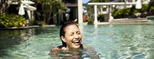 Woman swimming in hotel pool