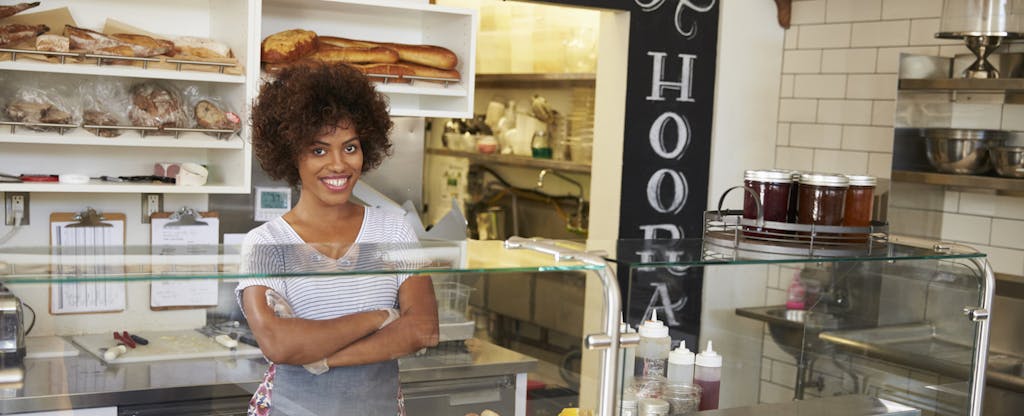 Businesswoman smiles after learning how to get a small-business loan