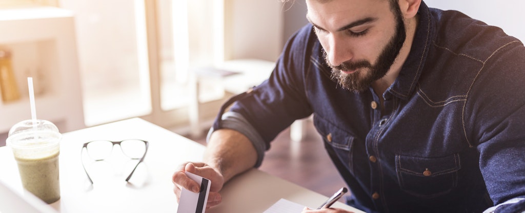 Man sitting at desk shops online.