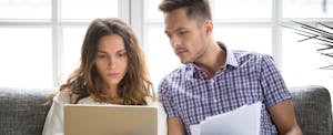 Worried couple researches how to get a personal loan with bad credit