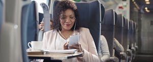 Woman using smartphone on plane or train