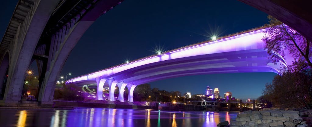 Purple light illuminates the underside of the 35W bridge in Minneapolis, in tribute to one of the city's most famous natives, Prince.