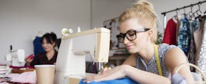 Woman in sewing business working on sewing machine