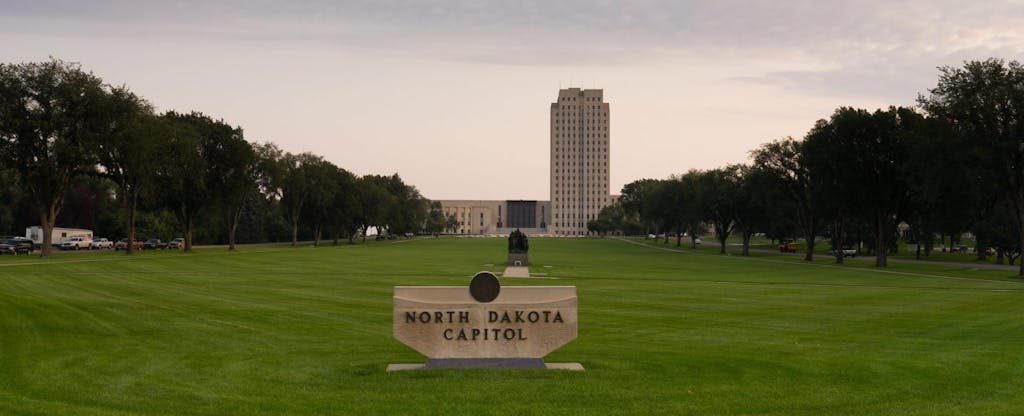 The State Capital grounds in Bismark, North Dakota are home to the states legislature, which establishes North Dakota state tax laws.