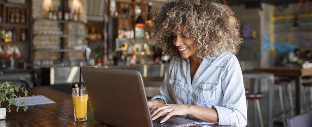 Young African-American woman working on her laptop, doing her taxes, confident she has the last-minute tax tips she needs to do the job right.