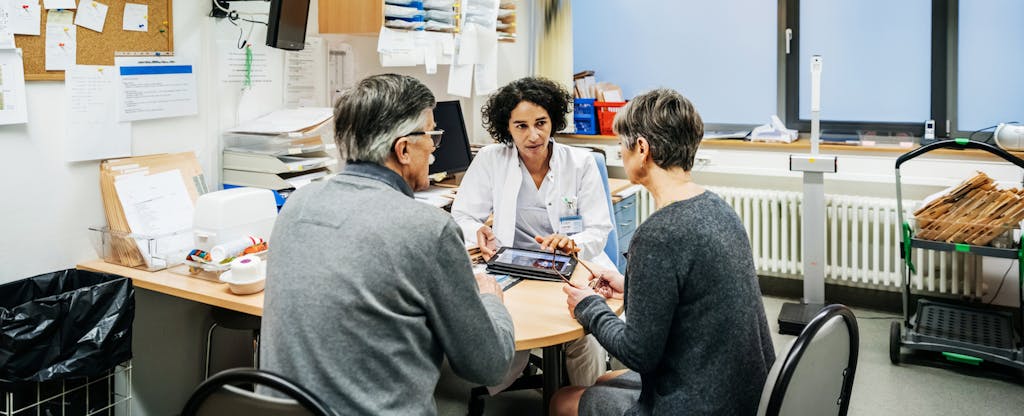 Doctor talking to a patient and his wife