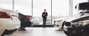 Woman looking at cars in a dealership