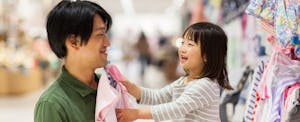 Father shopping for a dress with his young daughter