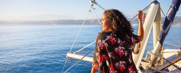 Woman sitting on a boat and looking out over the view