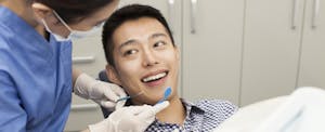 Man smiling at the dentist before his clearning