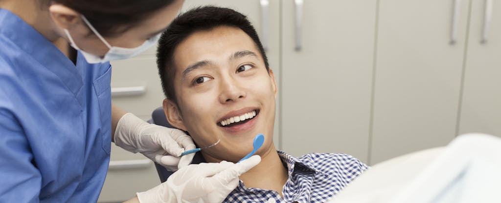 Man smiling at the dentist before his clearning