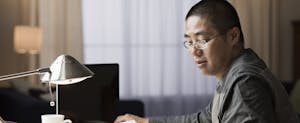 Man sitting at his desk, checking his mail