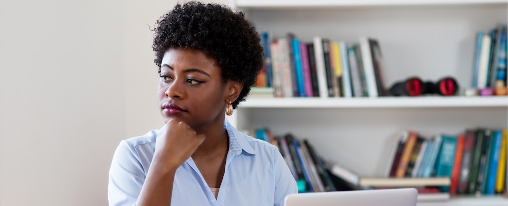 Woman sitting at her desk with her laptop open