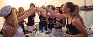 Ladies celebrating bachelorette party outside on a boat