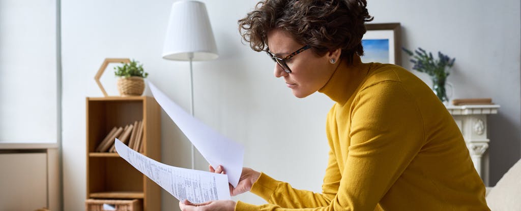 Young woman looking at Form 1099-C and wondering if she has to pay taxes on canceled debt