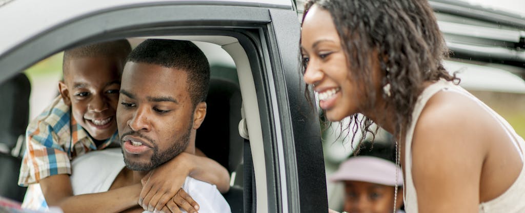 Family planning the route of their road trip in the car