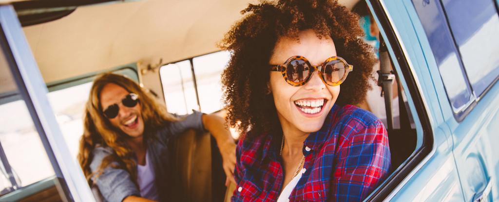 Smiling man and woman on a road trip