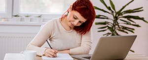 Woman in home office doing paperwork