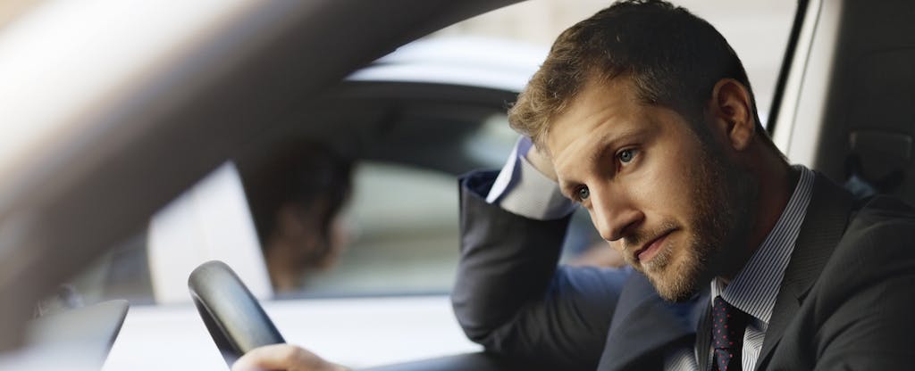 Man driving his car, looking stressed