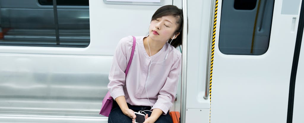 Tired woman listening music and sleeping