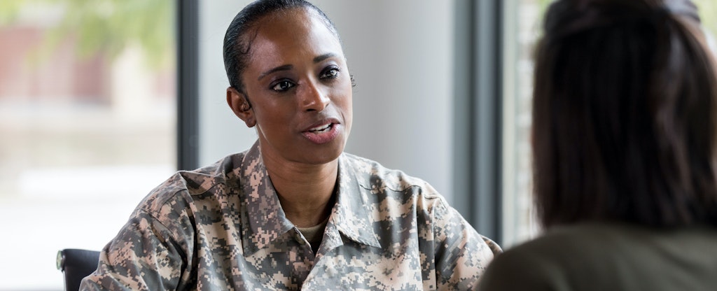 Female soldier talks with a financial counselor about an AER loan