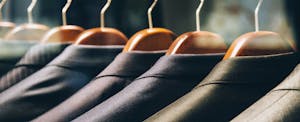 Men's suit jackets hanging in a clothing store