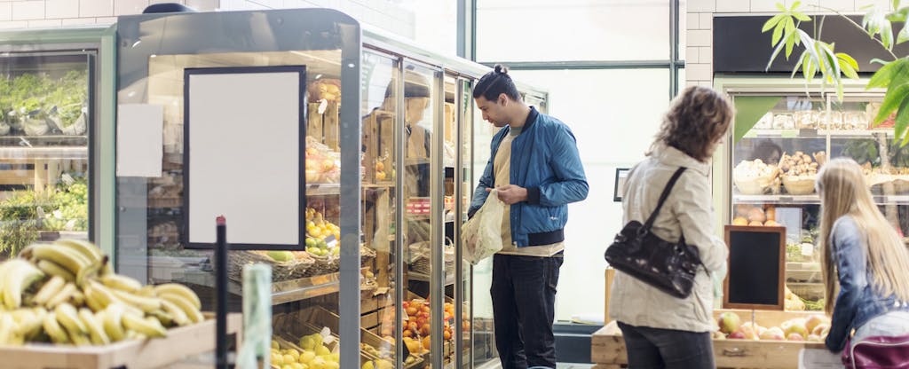 Customers buying groceries in supermarket