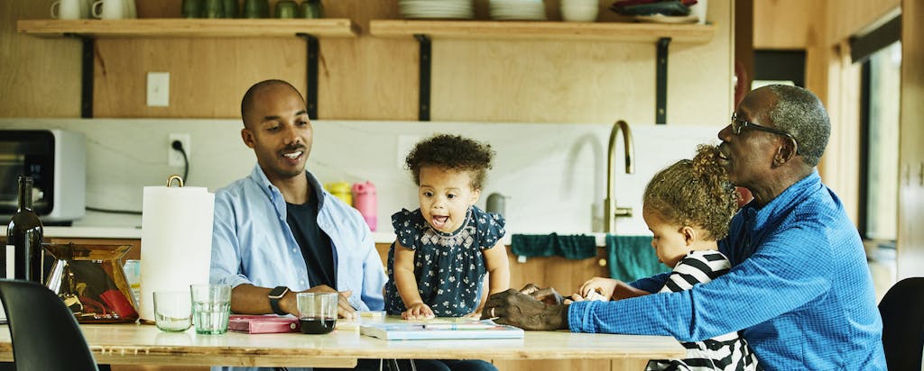 parents and children at home kitchen table