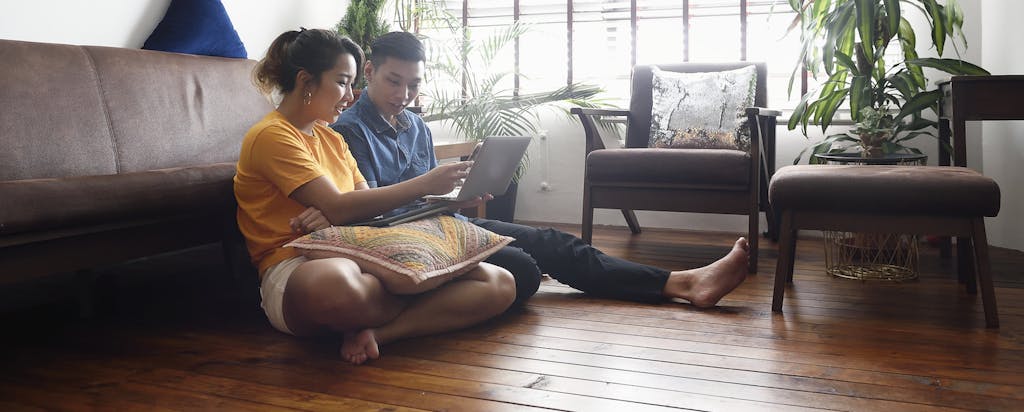 Couple on living room floor discussing future