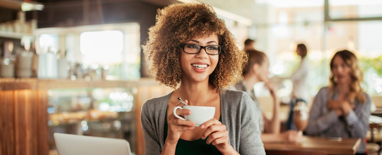 A young women enjoys coffee in cafe