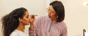 Makeup artist applying product to a client's face