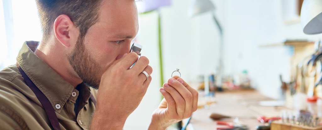 Jeweler appraising ring in a pawn shop