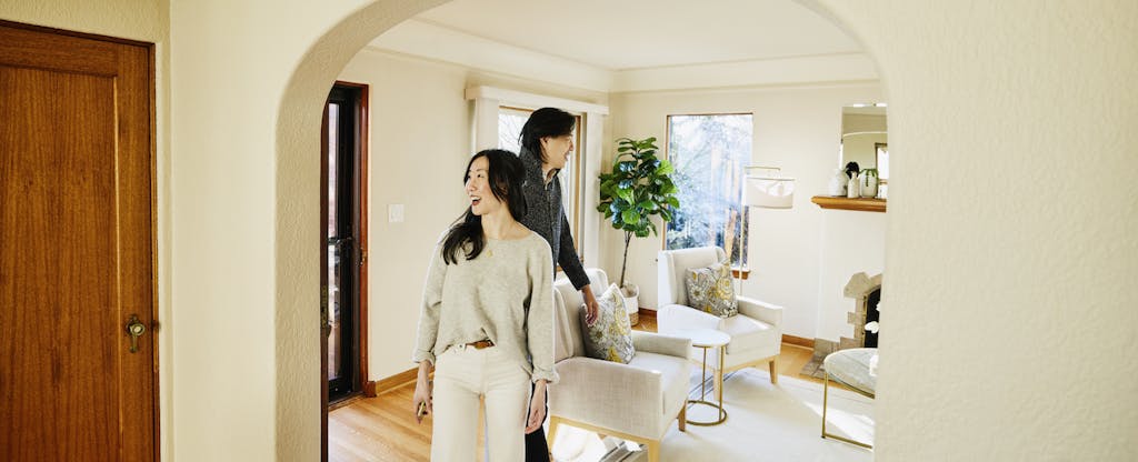 Young couple touring their home, which they purchased with an interest-only mortgage.