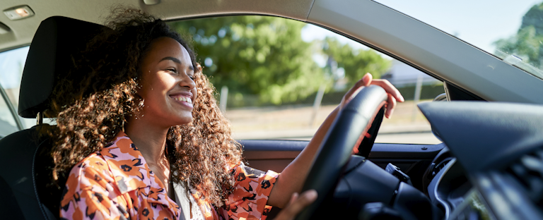 Young driver, smiling behind the wheel