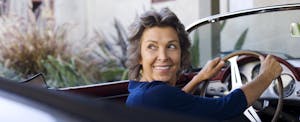 Woman driving her car insured with GoAuto insurance