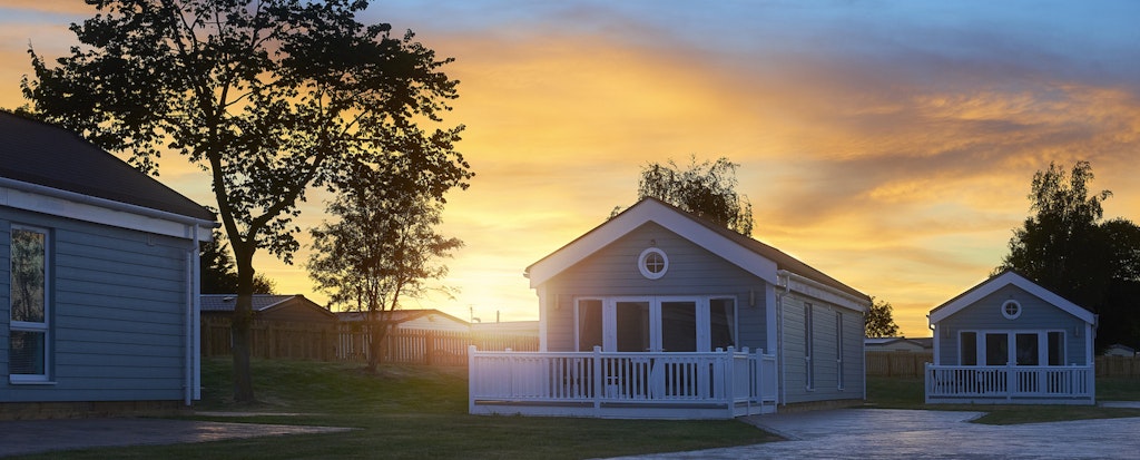 A row of manufactured homes with beautiful sunset sky in the background