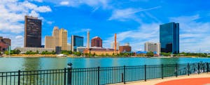 Skyline view of downtown Toledo, riverwalk and river in foreground