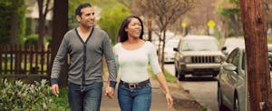 Young couple walking through their neighborhood