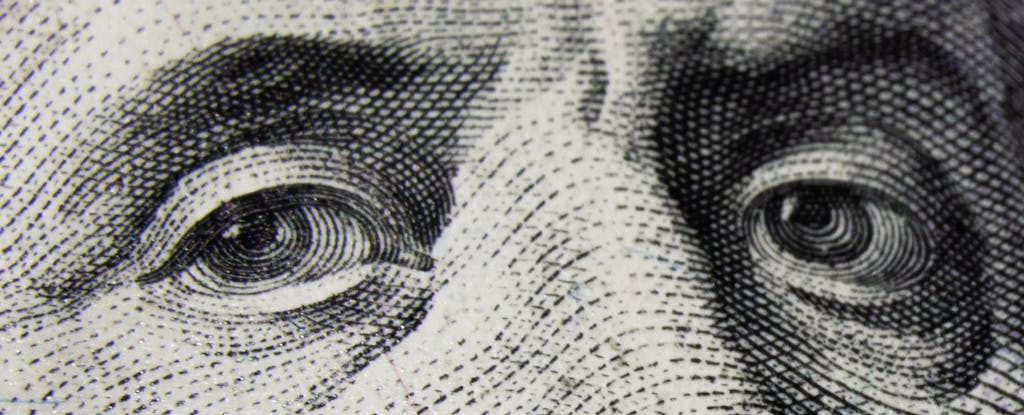 Close-up of a U.S. $100 bill, showing Benjamin Franklins eyes